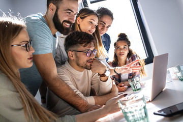 A group of programmers congregates in a conference room, engaged in animated discussions,...