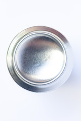 Bottom view close up of silver aluminum can isolated on white background, unpainted and selective focus. Concept of drinks, industry, soda, beer, model, manufactures, recycling and object.