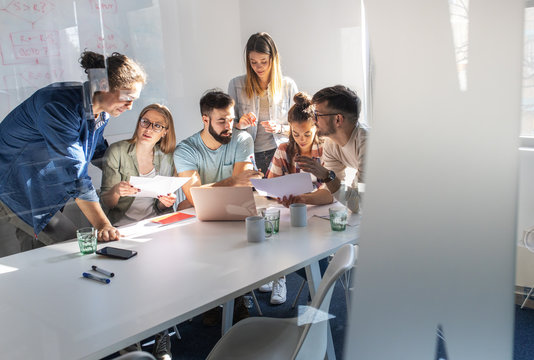 A group of programmers congregates in a conference room, engaged in animated discussions, brainstorming ideas, and strategizing to bring their new project to life with precision and innovation.