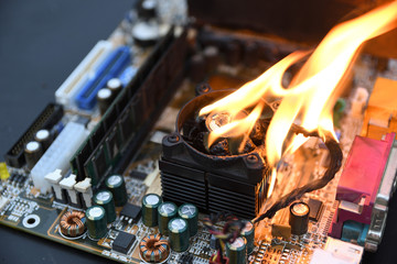 Fire Burning ,blazing computer motherboard, cpu,gpu and video card, processor on circuit board with...