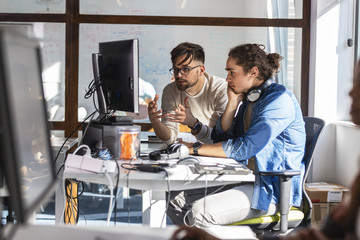 Two programmers at the office.They discuss and working on new project.
