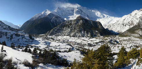 Annapurna Circuit track. View at Anapurna II Peak (7 937 m), Upper and Lower Pisang villages.