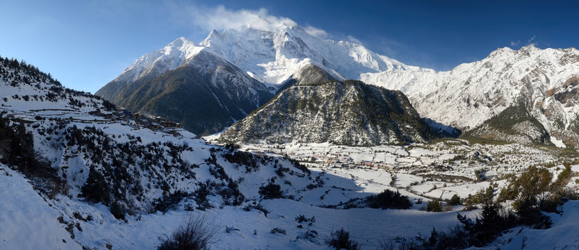 Annapurna Circuit track. View at Anapurna II Peak (7 937 m), Upper and Lower Pisang villages.
