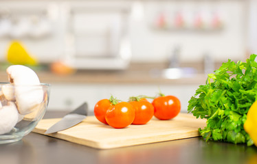 Ripe cherry tomatoes on kitchen table.