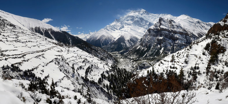 Annapurna Circuit track. View at Anapurna and Ghyaru village.