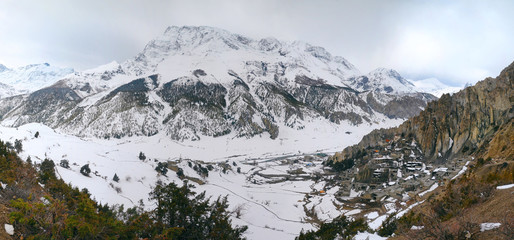Annapurna Circuit track. View at Anapurna III Peak (7 555 m) Gangapurna Peak (7 455 m) and traditional nepalese Barka village.