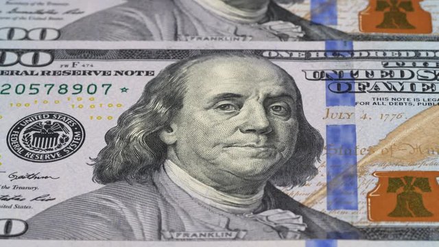 US 100 dollar bills close up tracking. USA federal fed reserve notes background. Slider shot, low angle. 4K, 422 10 bit