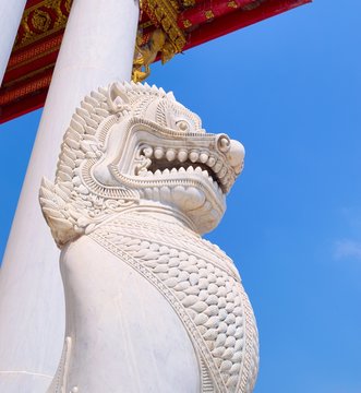 Imperial guardian lion, made of Carrara marble, at the entrance of Wat Benchamabophit temple, in Bangkok, Thailand.