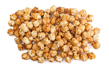 Heap of delicious caramel popcorn, isolated on white background . Scattered popcorn texture background.