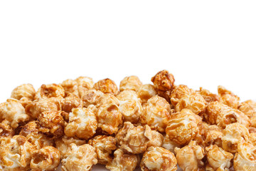 Heap of delicious caramel popcorn, isolated on white background. Scattered popcorn texture background . Selective focus.