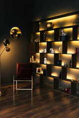 The interior of a modern apartment in black with yellow lighting. Beautiful interior decor