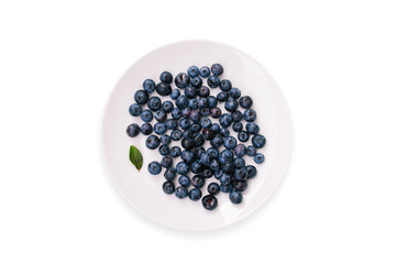Blueberries in a plate isolated on a white background.