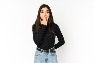 Young indian woman isolated on purple background shocked, covering mouth with hands, anxious to...