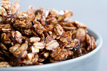 Macro shot of homemade cocoa granola with crunchy peanuts and maple syrup. Morning light, high resolution