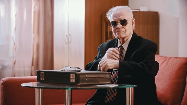 Elderly grandfather - old grandfather smugly crosses his arms over his chest