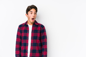 Young caucasian man posing in a pink background isolated being shocked because of something she has seen.
