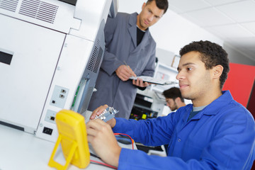 an electrician is inspecting printer
