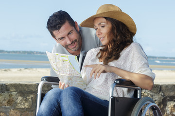 portrait of middle aged couple of tourists man in wheelchair