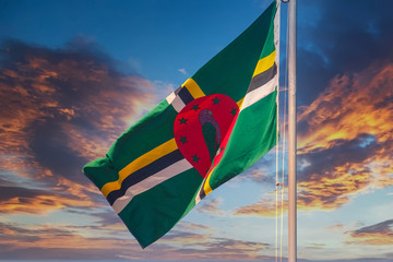 Flag of Dominica Blowing Against a Blue Sky Background