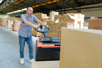 portrait of a warehouse worker carrying boxes