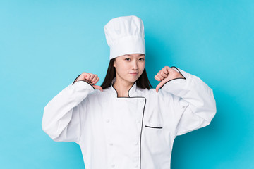 Young chinese chef woman isolated feels proud and self confident, example to follow.