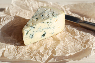 blue cheese on parchment on a light background close-up