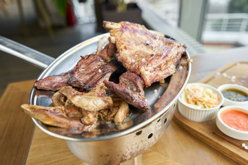 Various grilled meat set heated on coals. Barbecue restaurant menu. Many different food on the table. Dinner party or Banquet