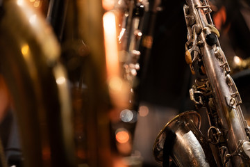 A vintage looking tenor saxophone resting in its stand during a jazz concert