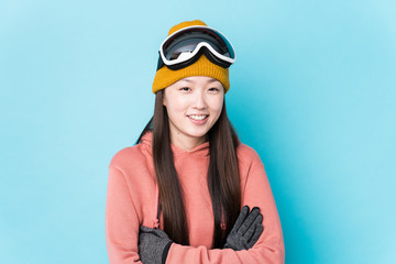 Young chinese woman wearing ski clothes isolated laughing and having fun.