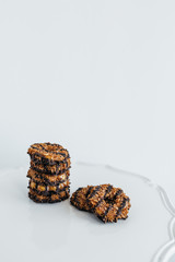 Stack of coconut and chocolate cookies on marble