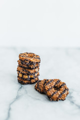 Stack of coconut and chocolate cookies on marble