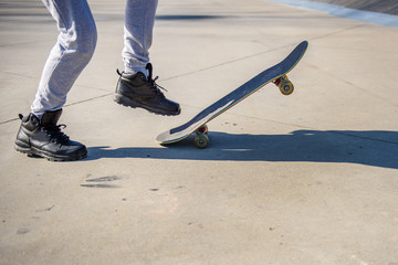 Fototapeta na wymiar Unrecognizable skater in skatepark with his skateboard