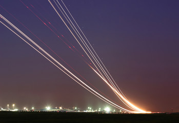 Long time exposure of taking off and landing aircrafts  forming a curves in the sky