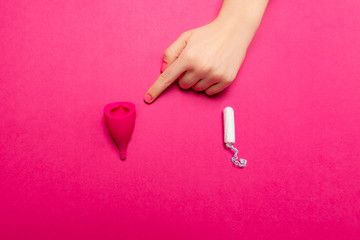 Hygiene items for womens critical days, such as menstrual cup and a tampon. Alternative healthy...