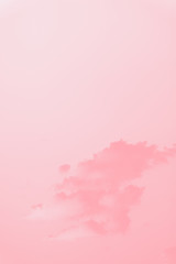Scenic sky. Beautiful soft fluffy clouds on a clear sky background. Pink coral toned, copy space