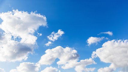 Sky background. Blue sky with fluffy white clouds. Copy space, 16:9 panoramic format