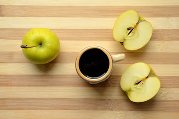 beer mug and green apples on wooden table 