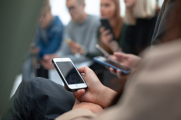 image of a smartphone in the hands of a young man