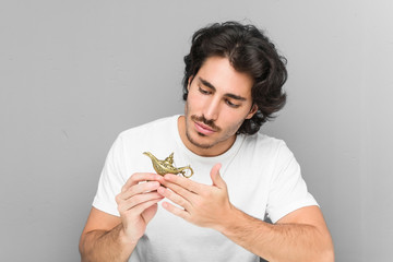 young man looking to a magic lamp