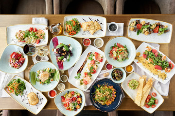 Many different delicious dishes dishes on the table. Various snacks and antipasti on the table. Restaurant menu. Italian cuisine