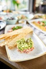 Salad crab, avocado, citrus oil, spices. Crab meat with matzo on white plate for cooked seafood.