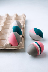 Rustic Easter Eggs. Still life of beautiful painted Easter eggs on white table. Concept for individuality, being different, organic, tattoo on egg.