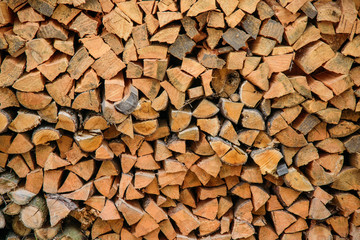 Chopped wood stacked firewood in a pile background