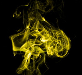Obraz premium Yellow smoke on black background
