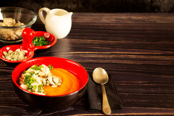 Pumpkin puree soup with chicken meat, pumpkin seeds and green onions. Dish for a healthy diet. Vegetable cream soup. Copy space.