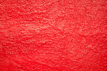 Full frame textured background of shiny red painted wall 