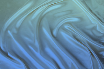 soft folds on delicate blue shiny silk, luxury concept, background for the designer, horizontal, close-up, copy space