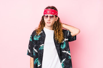 Young hippie caucasian man isolated suffering neck pain due to sedentary lifestyle.