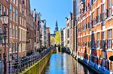 Scenic architecture of Amsterdam with canal houses and Old Church spire, Netherlands