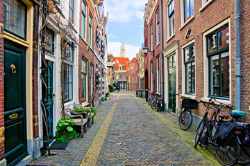 Quaint cobblestone Dutch street lined with bicycles, Haarlem, Netherlands